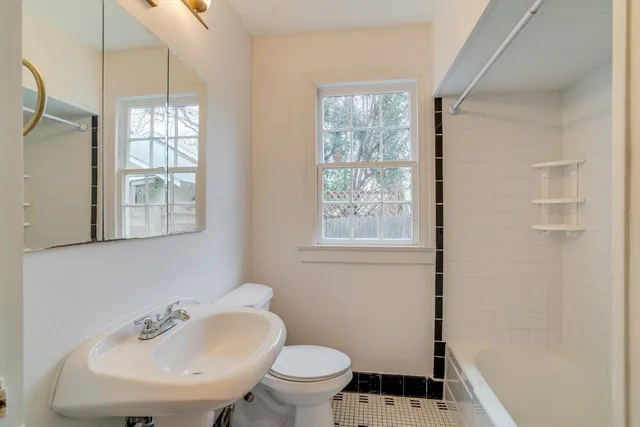 a bathroom with a sink toilet and a mirror