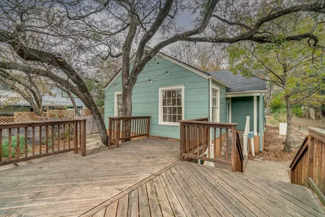 a view of house with deck and outdoor seating
