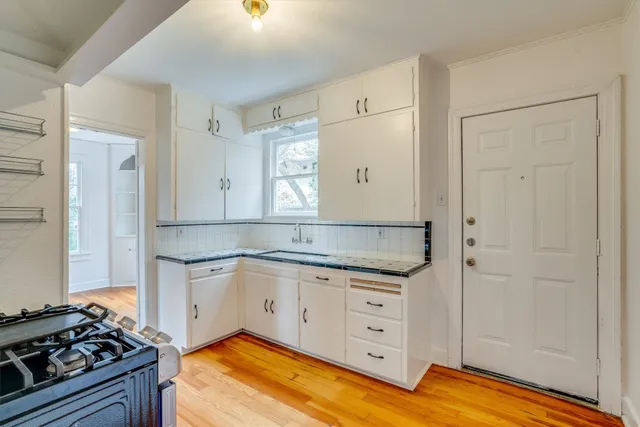 a kitchen with granite countertop a stove and a sink