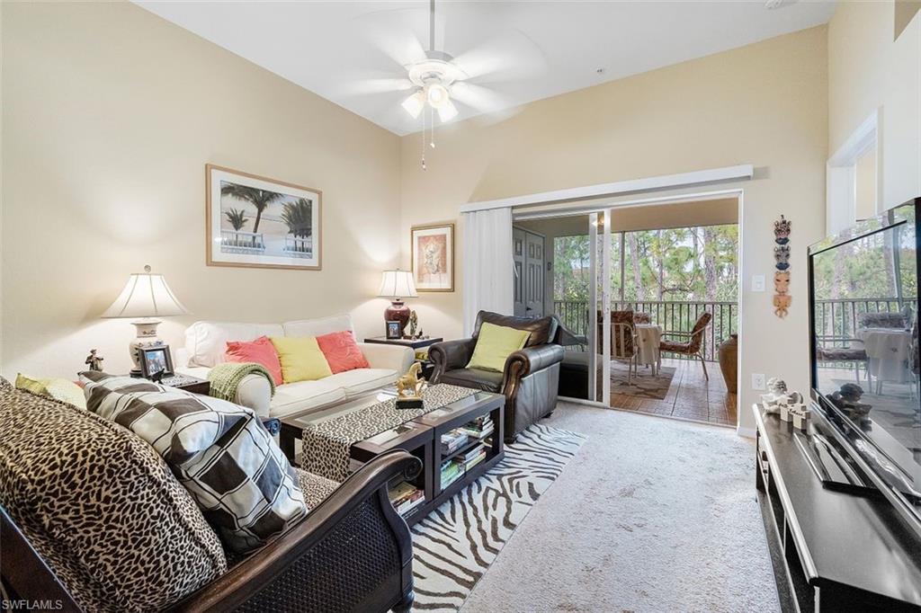 4500 Botanical Pl Circle, Unit 404 Naples, FL 34112 - Photo 13 of 31 Carpeted living room featuring ceiling fan