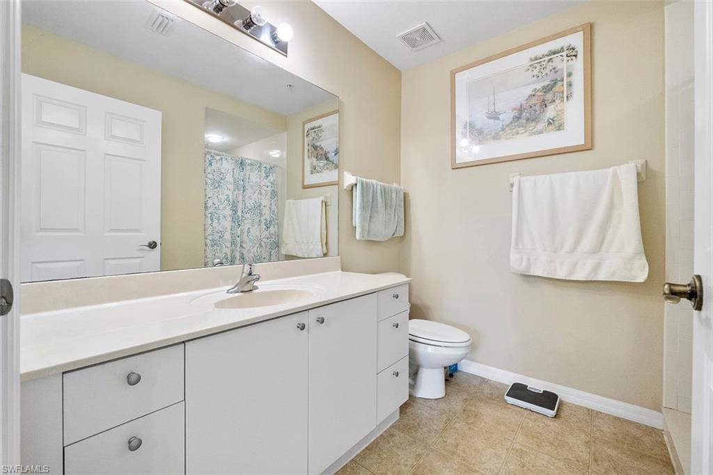 4500 Botanical Pl Circle, Unit 404 Naples, FL 34112 - Photo 20 of 31 Bathroom featuring toilet, vanity, and walk in shower