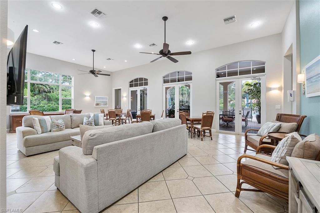 4500 Botanical Pl Circle, Unit 404 Naples, FL 34112 - Photo 27 of 31 Tiled living room with ceiling fan, french doors, and plenty of natural light