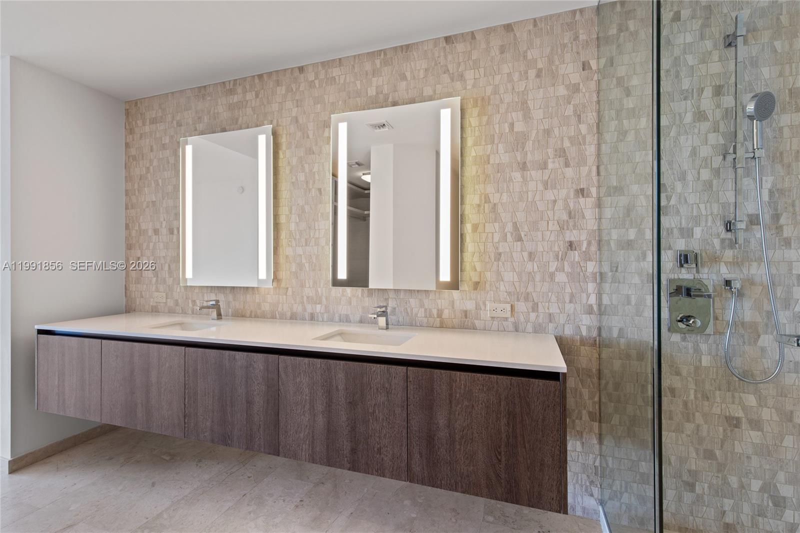 88 Southwest 7th Street, Unit 904 Miami, FL 33130 - Photo 15 of 26 a bathroom with double sink and a mirror