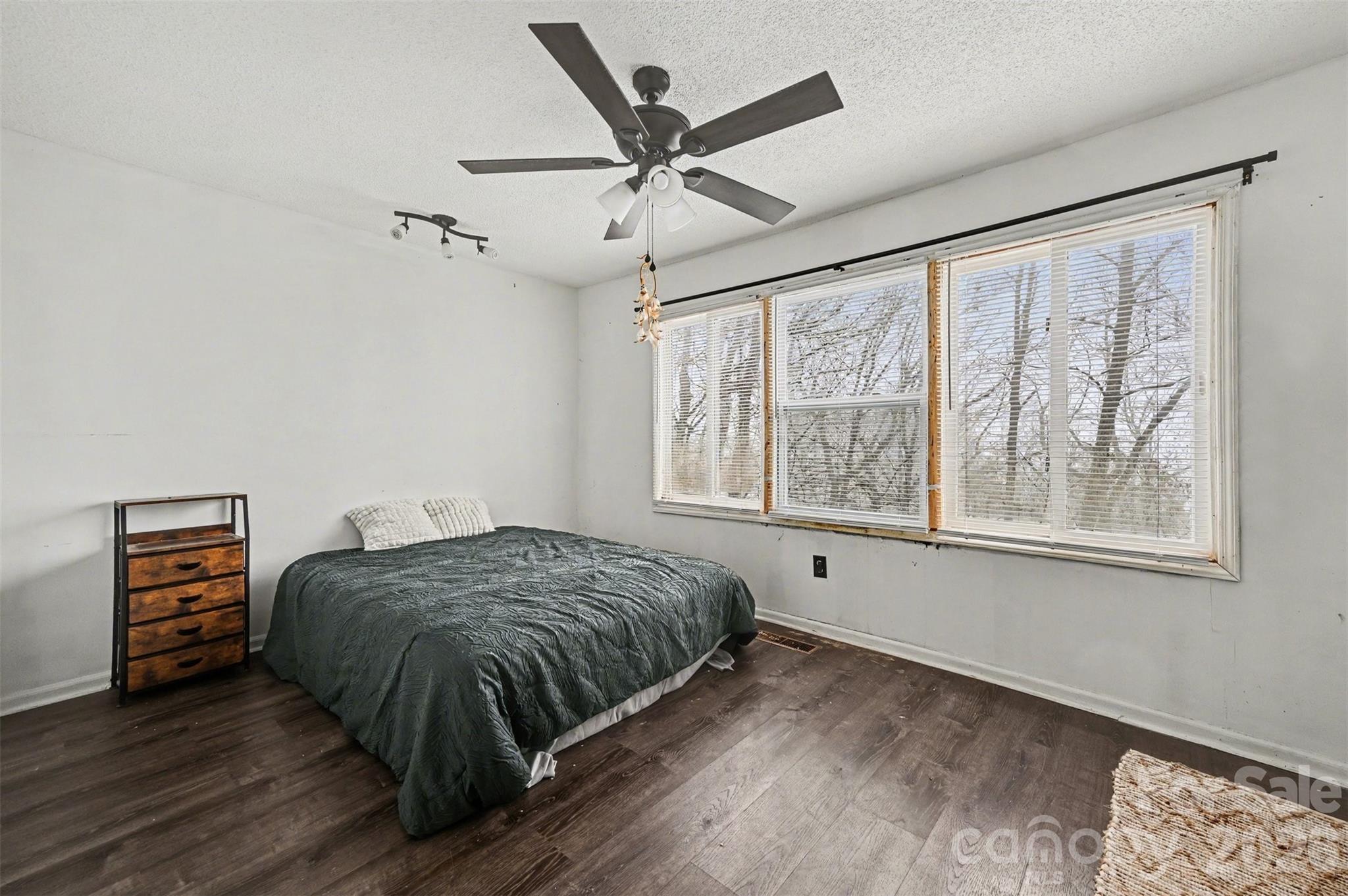 5495 Pine Ridge Drive Connelly Springs, NC 28612 - Photo 14 of 17 a bedroom with a bed and a large window with wooden floor