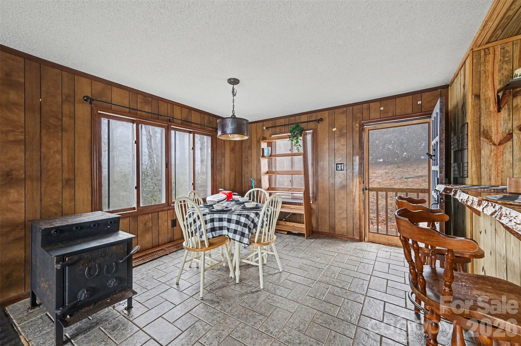 5495 Pine Ridge Drive Connelly Springs, NC 28612 - Photo 6 of 17 a dining room with furniture a chandelier and wooden floor