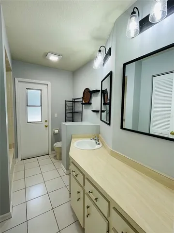 a spacious bathroom with a sink and a mirror