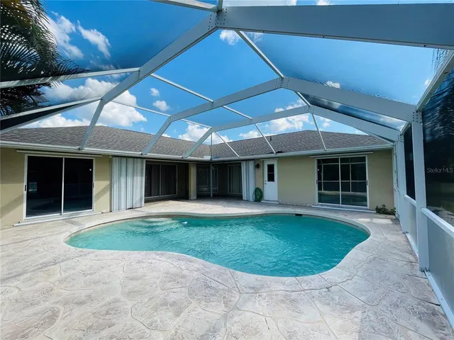 a view of a house with a backyard and porch