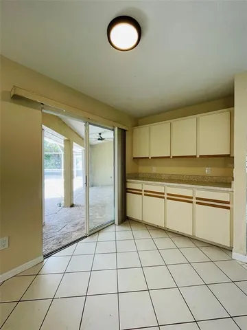 a large white kitchen with a sink and cabinets
