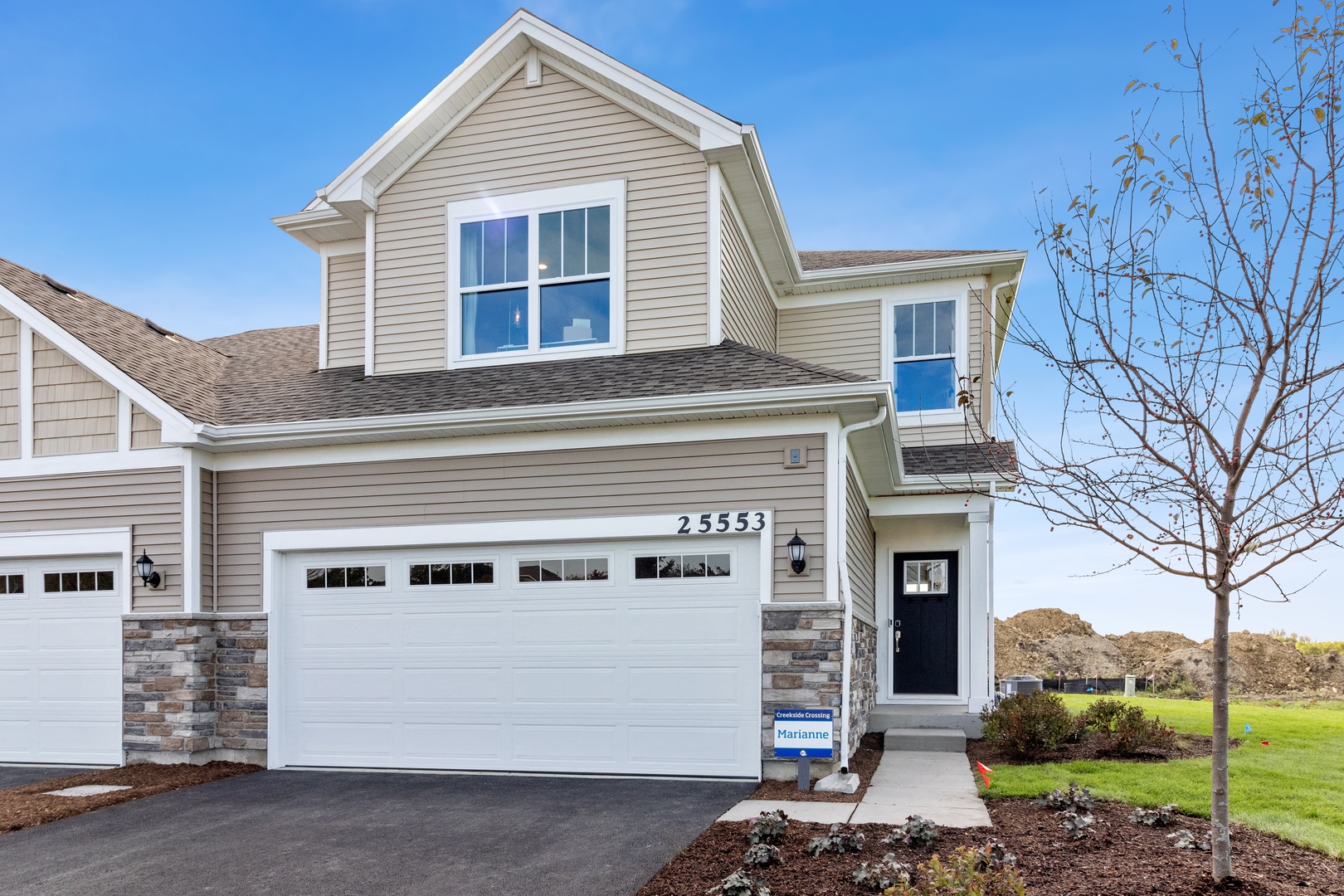 a front view of a house with a garage