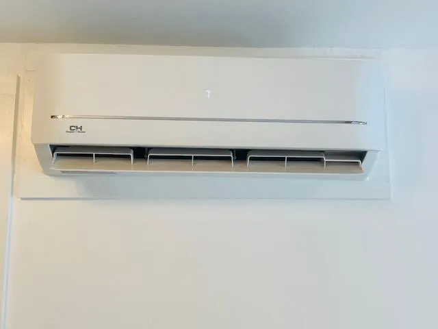 a backyard of a house with barbeque oven table and chairs