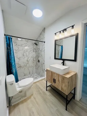 a bathroom with a sink toilet and shower