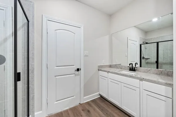 a bathroom with a granite countertop sink mirror and vanity