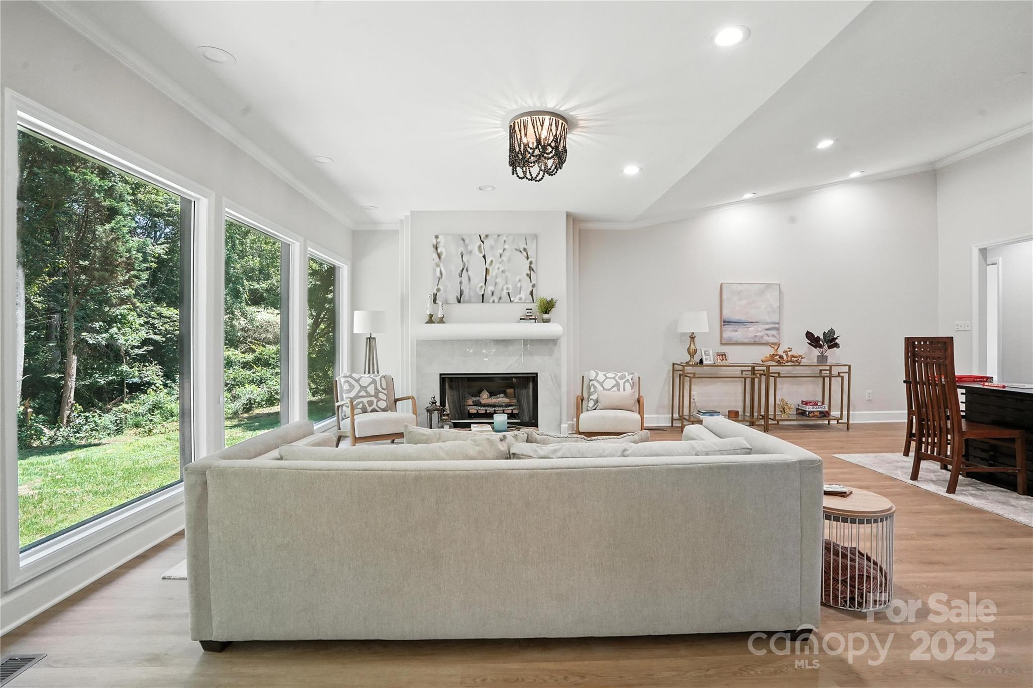 7109 Forney Hill Road Denver, NC 28037 - Photo 13 of 45 a living room with furniture a fireplace and a floor to ceiling window