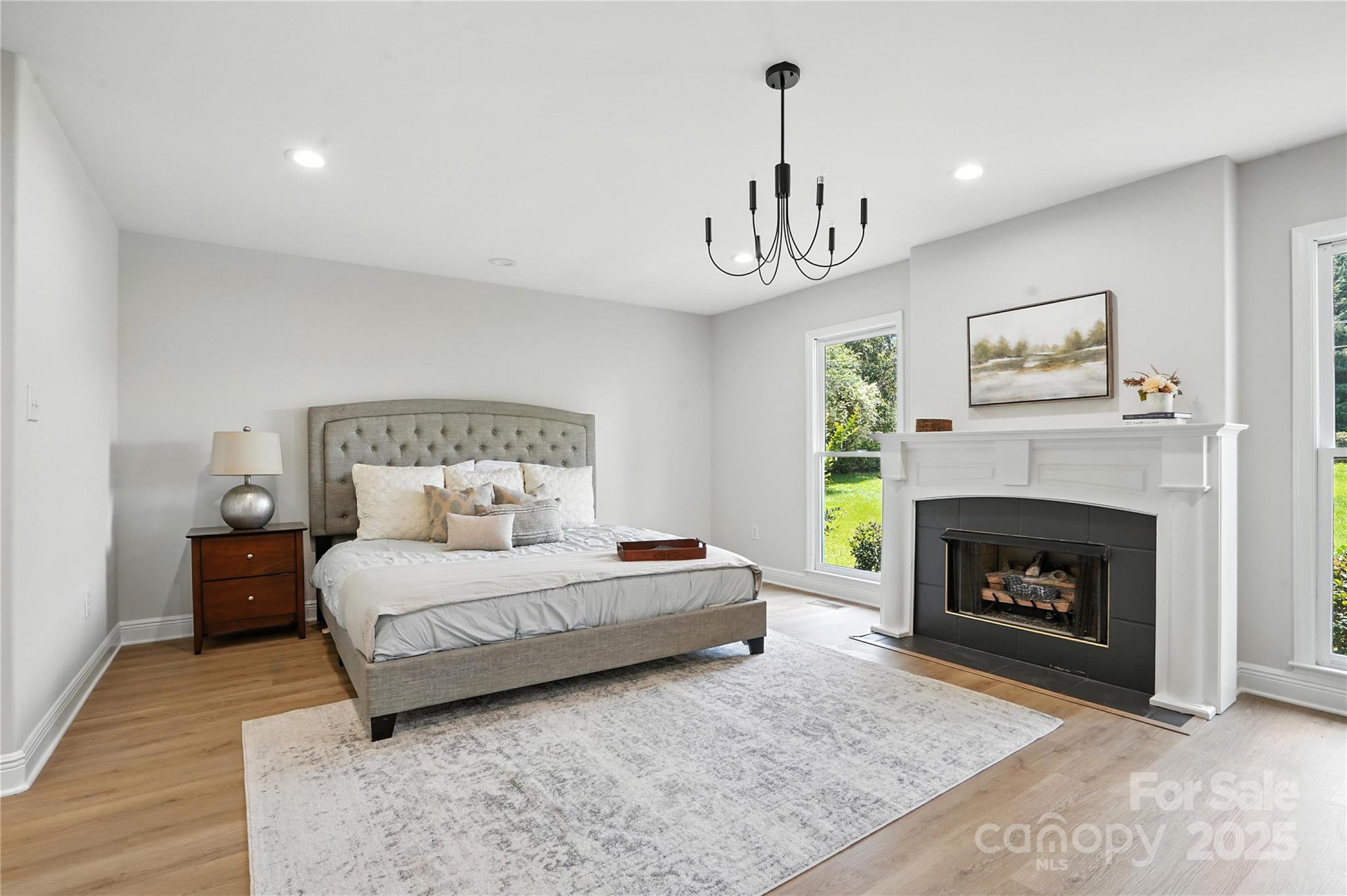 7109 Forney Hill Road Denver, NC 28037 - Photo 19 of 45 a bedroom with a large bed and a fireplace