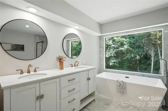 a bathroom with 2 sink tub and a mirror