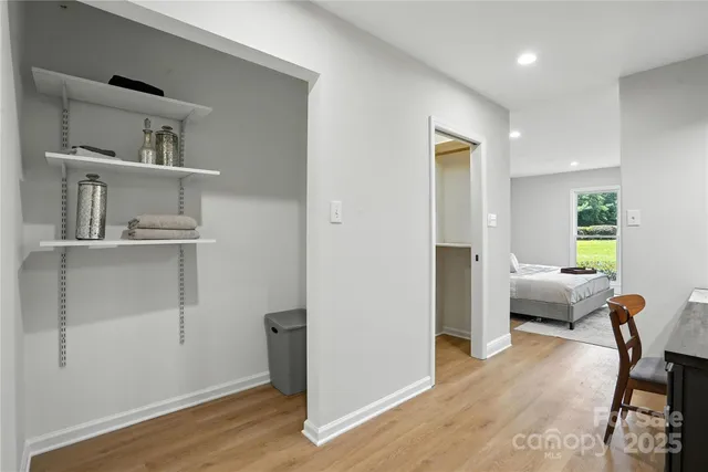 a view of a room with wooden floor