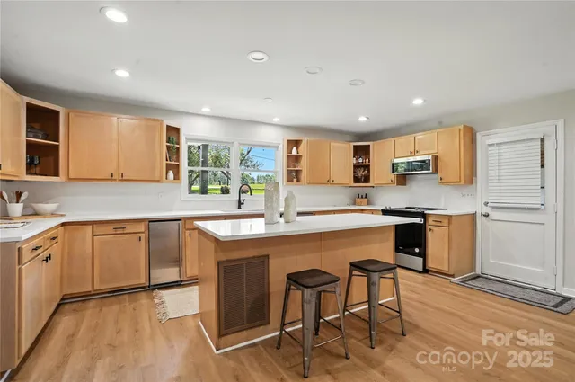 a kitchen with a sink cabinets and window