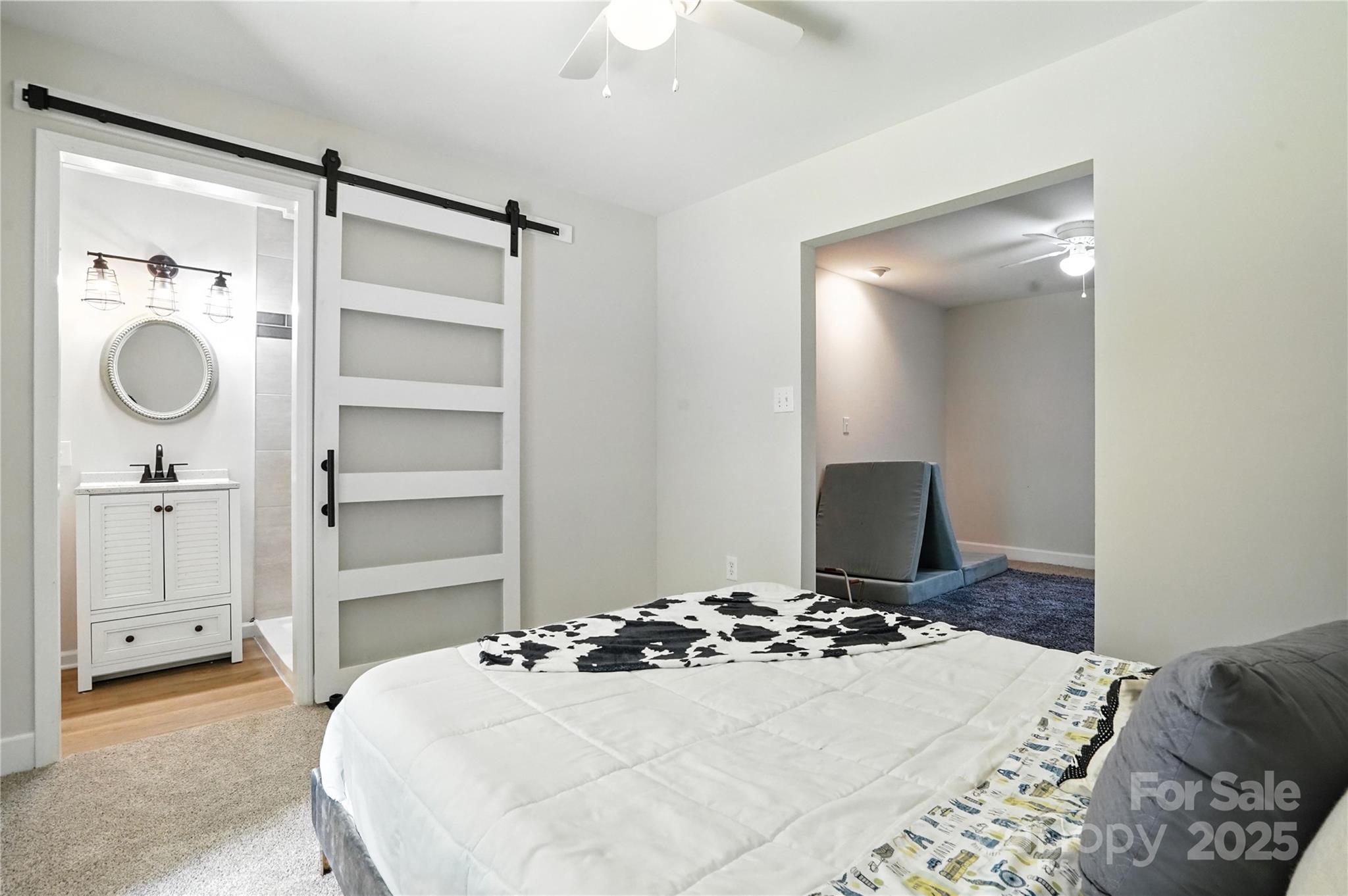 7109 Forney Hill Road Denver, NC 28037 - Photo 34 of 45 a bedroom with a bed and a chandelier