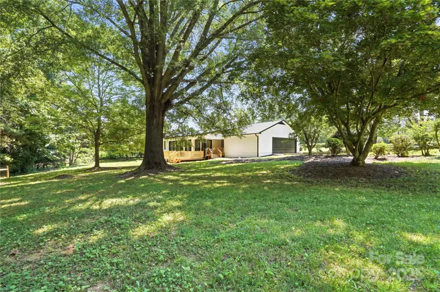 a view of a backyard with large trees
