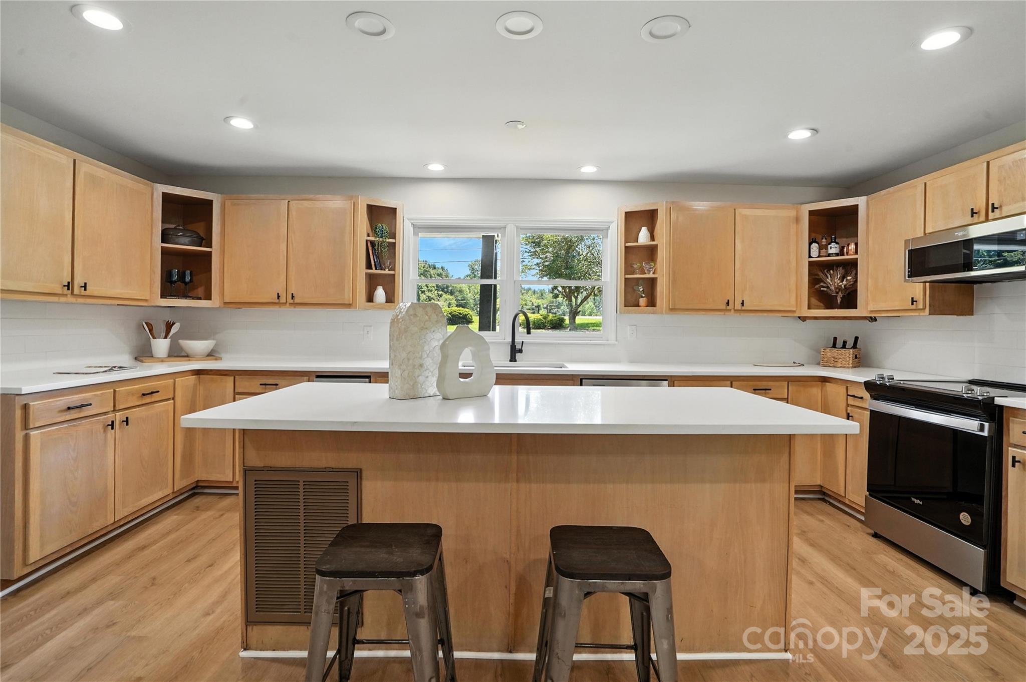 7109 Forney Hill Road Denver, NC 28037 - Photo 4 of 45 a kitchen with stainless steel appliances granite countertop a stove a sink a microwave and a refrigerator