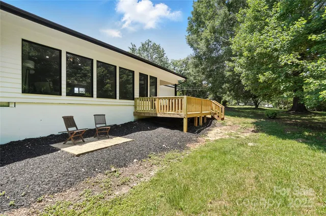 a balcony with wooden floor and outdoor seating