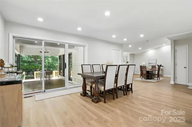 a view of a living room and kitchen with furniture floor to ceiling window