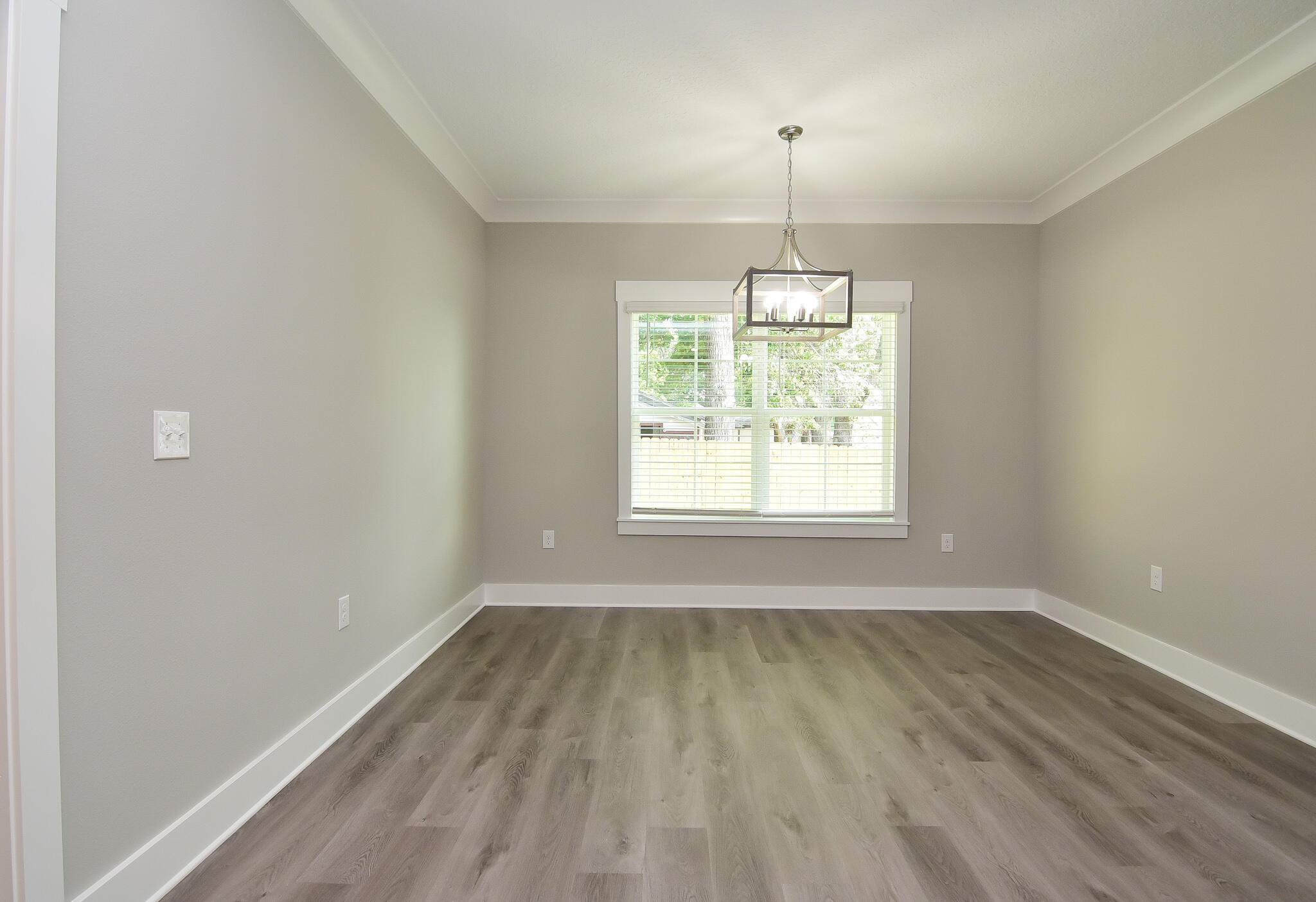 667 Red Fern Road Crestview, FL 32536 - Photo 12 of 32 an empty room with wooden floor and windows