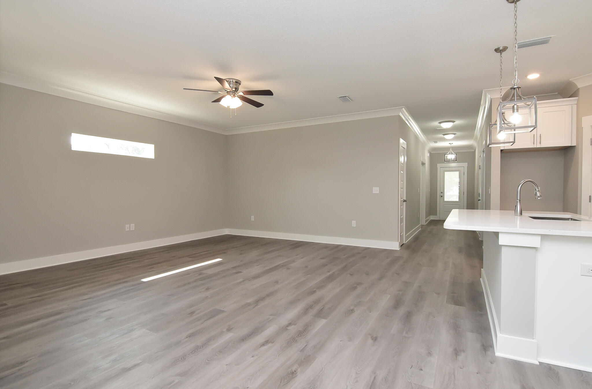 667 Red Fern Road Crestview, FL 32536 - Photo 13 of 32 an empty room with wooden floor and windows