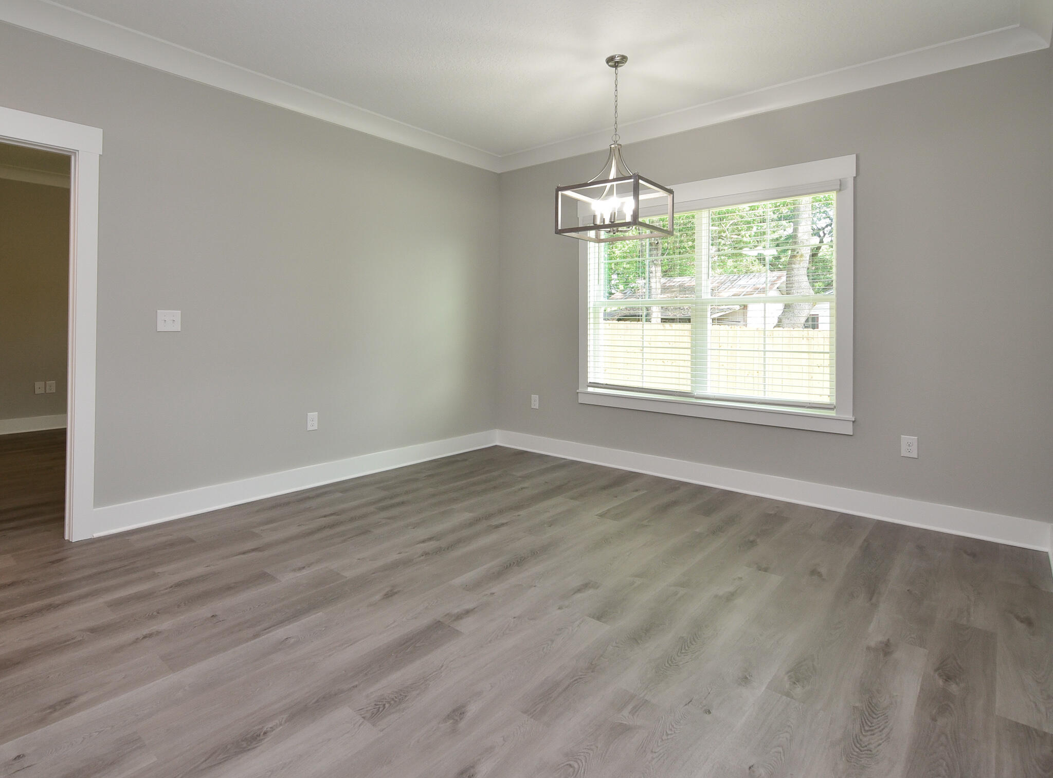 667 Red Fern Road Crestview, FL 32536 - Photo 14 of 32 an empty room with wooden floor and windows