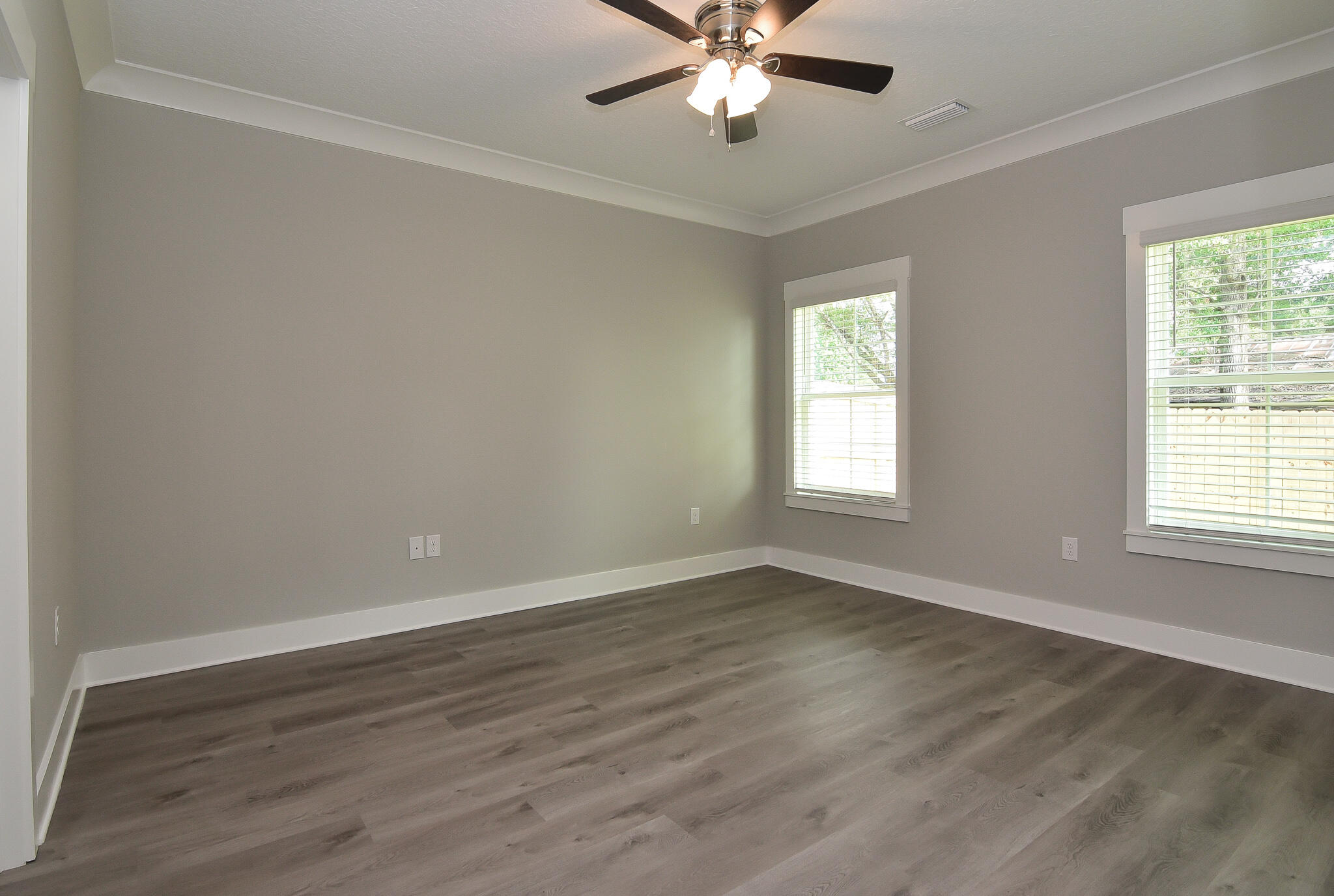 667 Red Fern Road Crestview, FL 32536 - Photo 15 of 32 a view of an empty room with wooden floor and a window