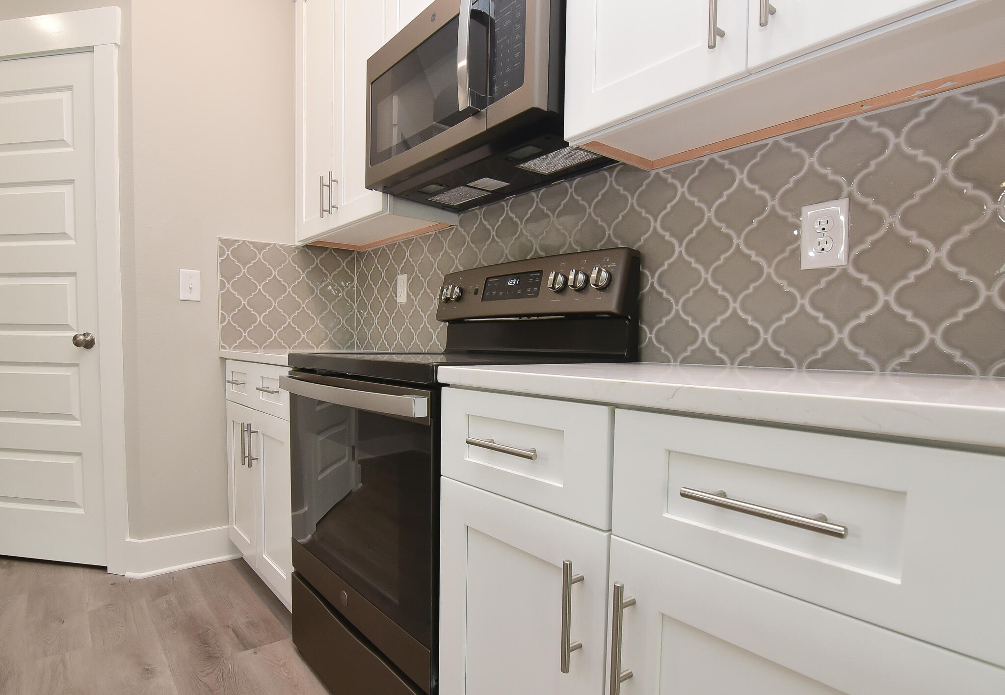 667 Red Fern Road Crestview, FL 32536 - Photo 24 of 32 a kitchen with white cabinets and black appliances