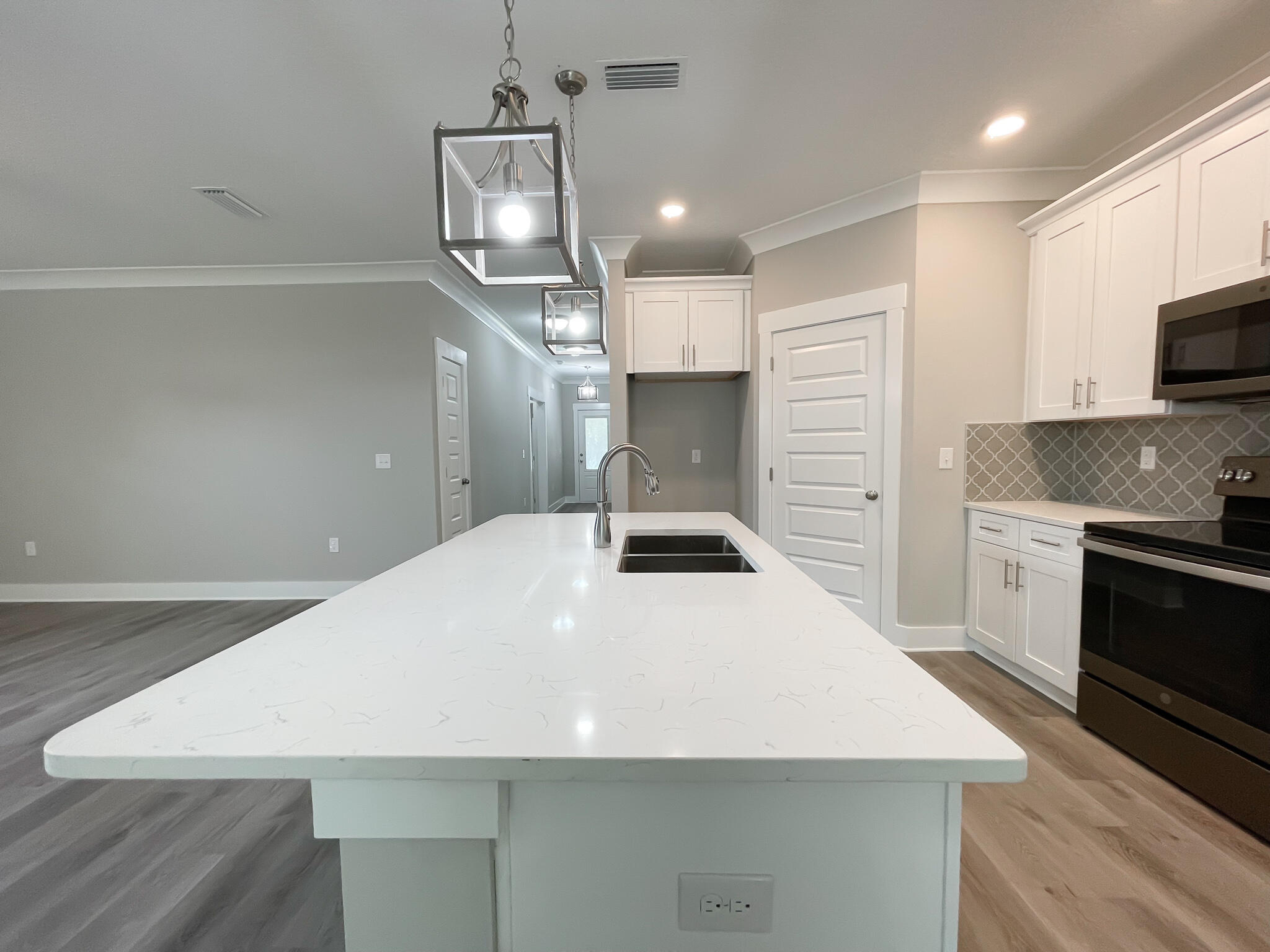 667 Red Fern Road Crestview, FL 32536 - Photo 30 of 32 a kitchen with a stove a sink and a refrigerator
