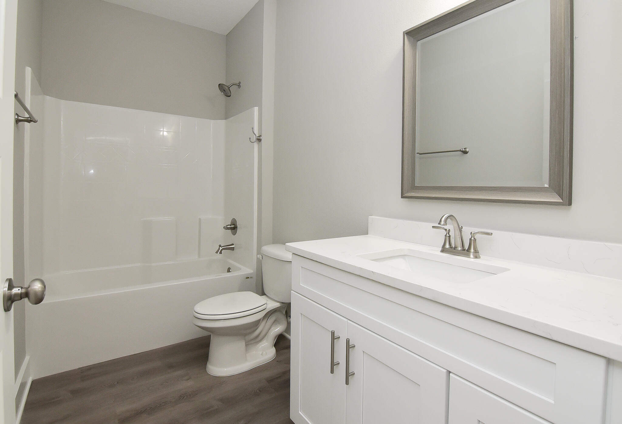 667 Red Fern Road Crestview, FL 32536 - Photo 3 of 32 a bathroom with a granite countertop sink a toilet and a large mirror