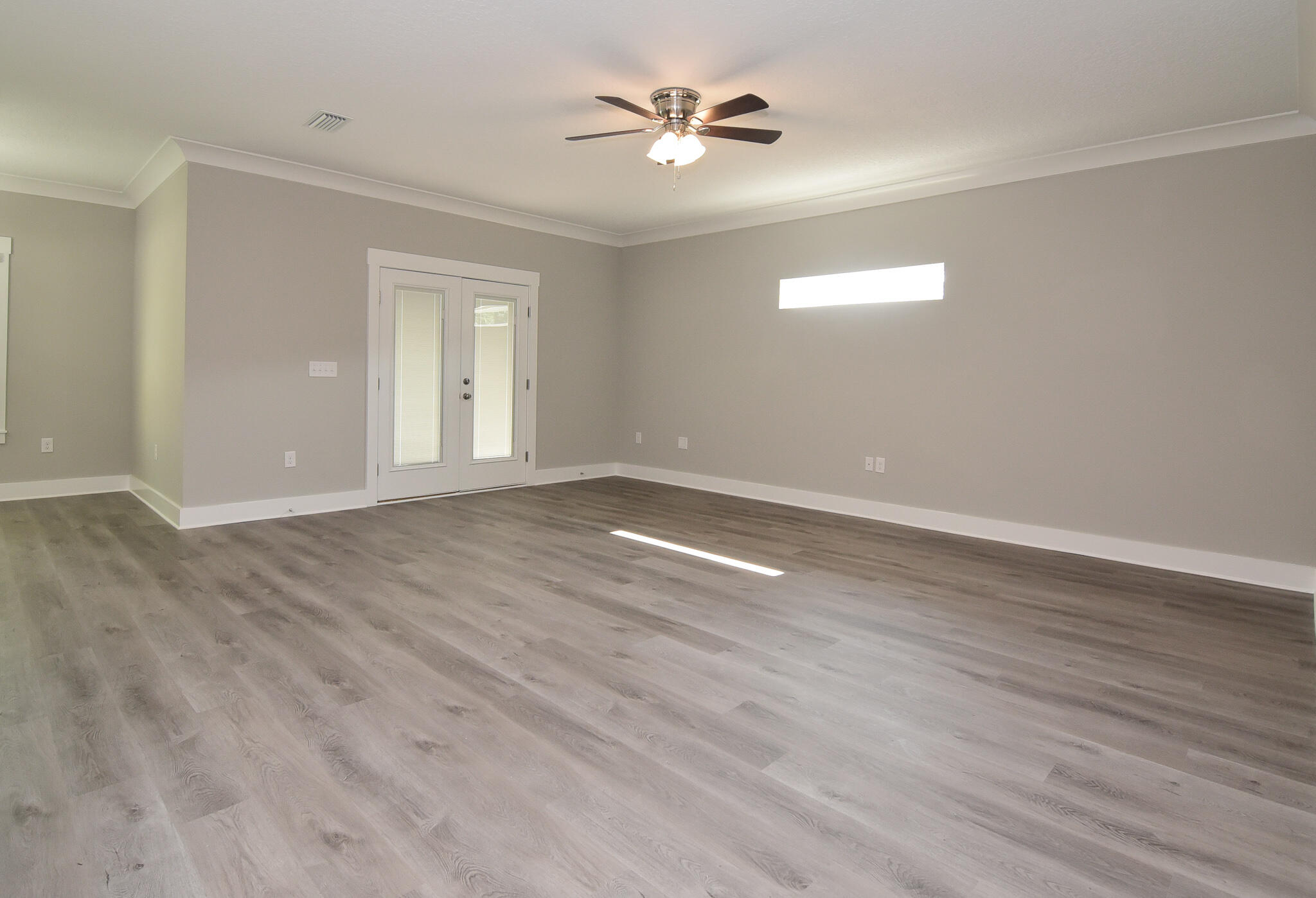 667 Red Fern Road Crestview, FL 32536 - Photo 7 of 32 wooden floor in an empty room with a window