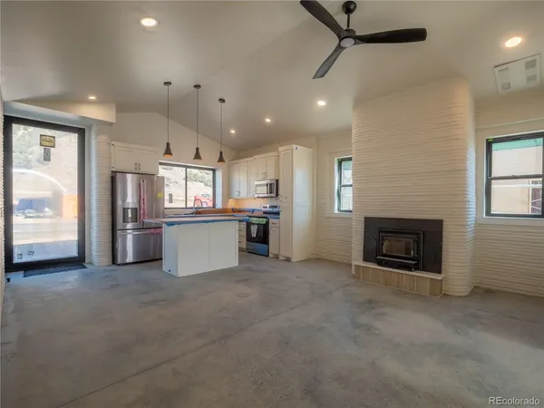 a view of a kitchen with a sink and a fireplace