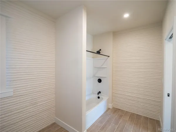 a bathroom with a bathtub and shower
