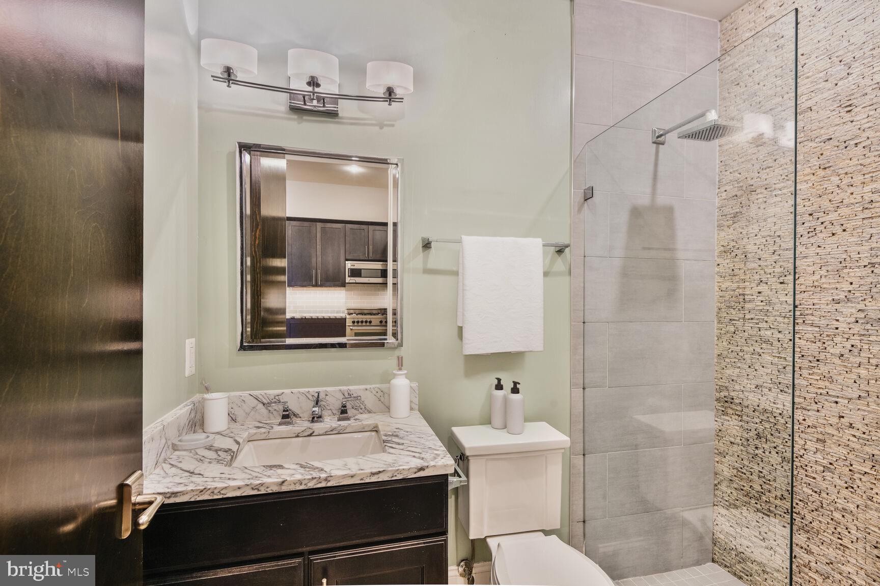 2009 Columbia Road Northwest, Unit 3 Washington, DC 20009 - Photo 12 of 16 a bathroom with a sink toilet and shower