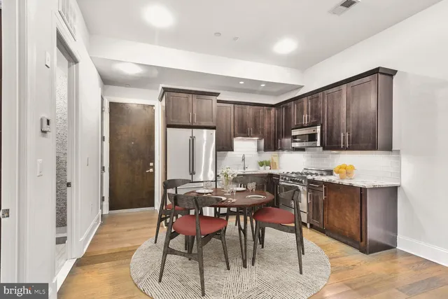 a view of kitchen with dining table and chairs