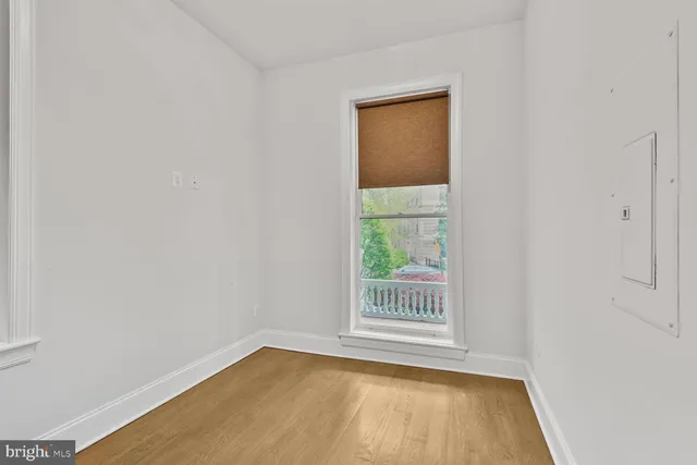 a bed sitting in a bedroom next to a window