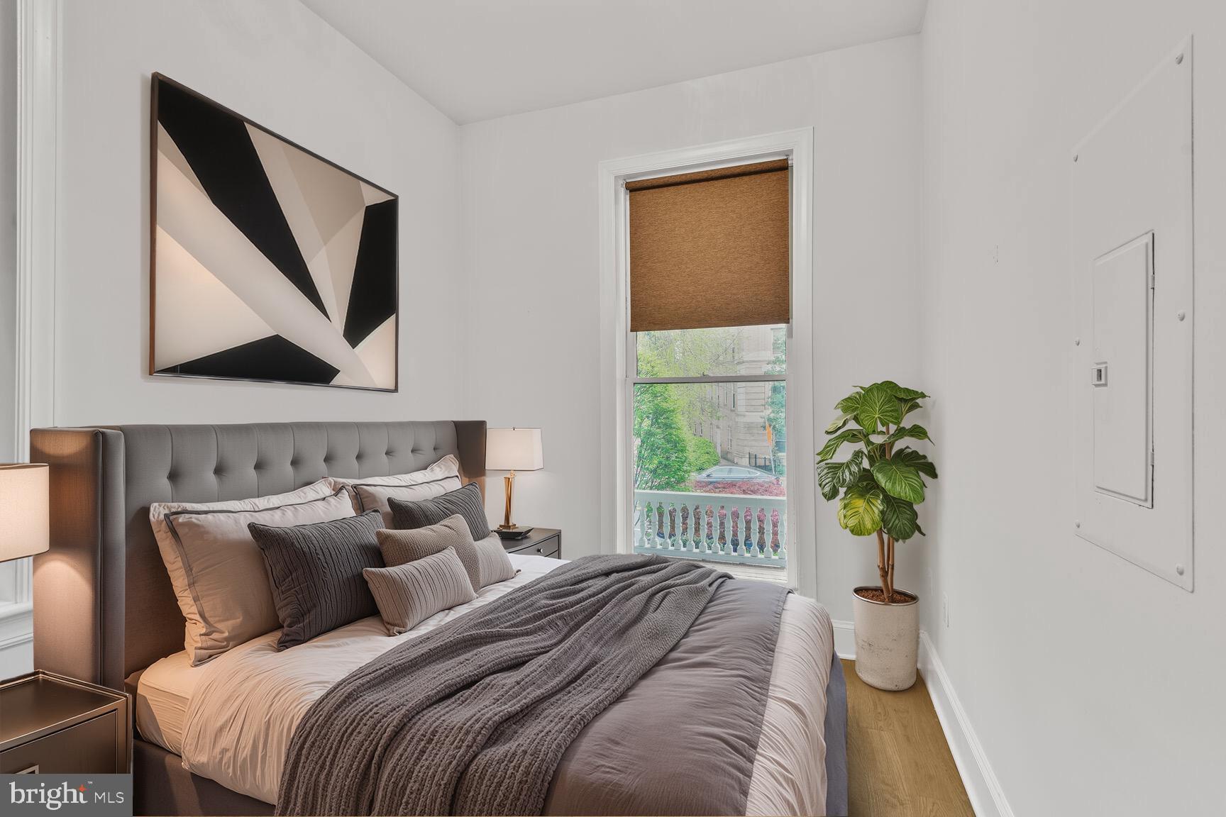 2009 Columbia Road Northwest, Unit 3 Washington, DC 20009 - Photo 10 of 16 a bed sitting in a bedroom next to a window