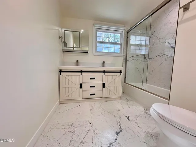 a bathroom with a bathtub sink and toilet