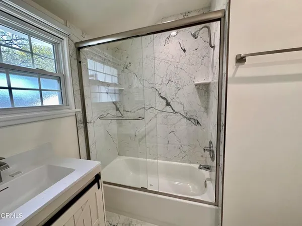 a bathroom with a tub and a sink