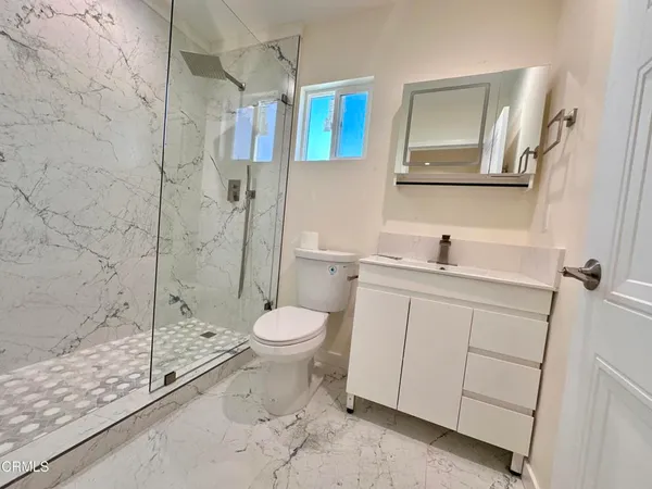 a bathroom with a toilet sink and a shower