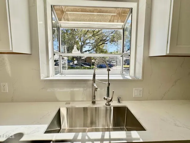 a kitchen with a sink and a window