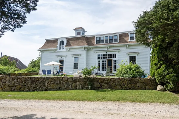 a front view of a house with a garden