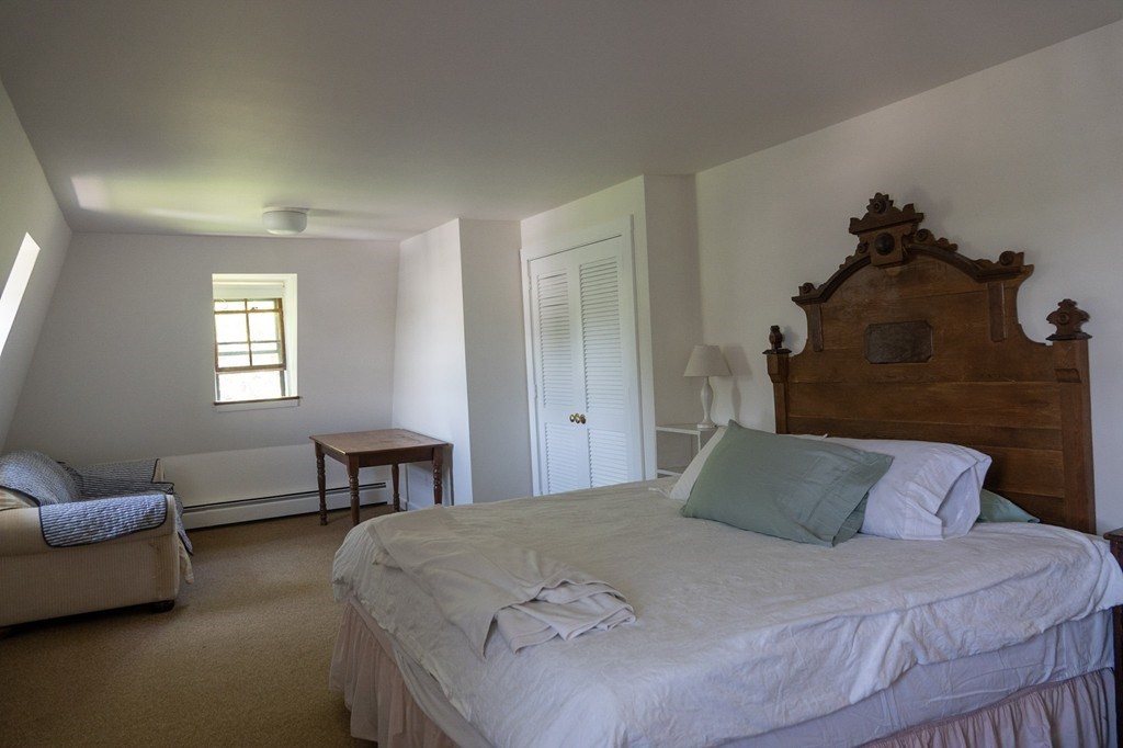 1991 B Main Road, Unit VAC RENTAL Westport, MA 02791 - Photo 13 of 17 a bedroom with a bed table chair and a window