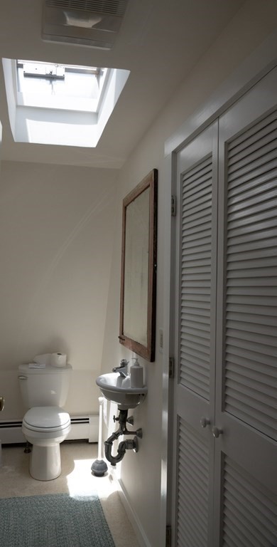 1991 B Main Road, Unit VAC RENTAL Westport, MA 02791 - Photo 16 of 17 a bathroom with a toilet a sink and mirror