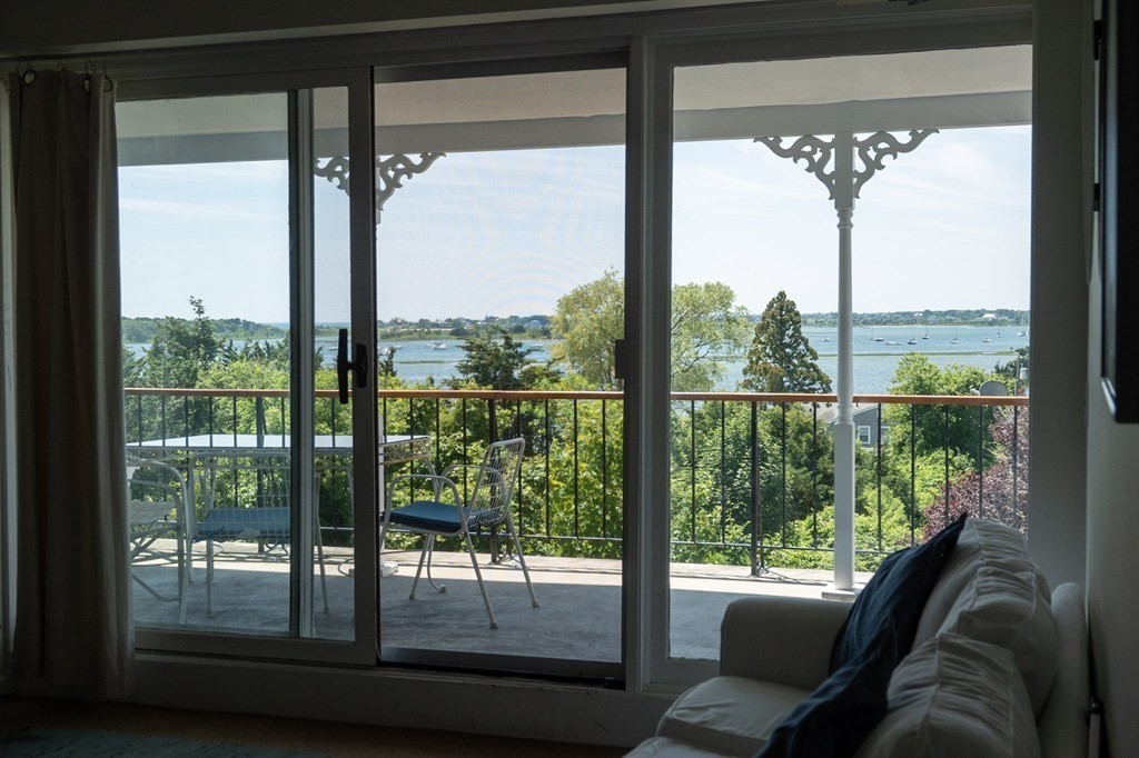 1991 B Main Road, Unit VAC RENTAL Westport, MA 02791 - Photo 9 of 17 a room with a large window and a bed