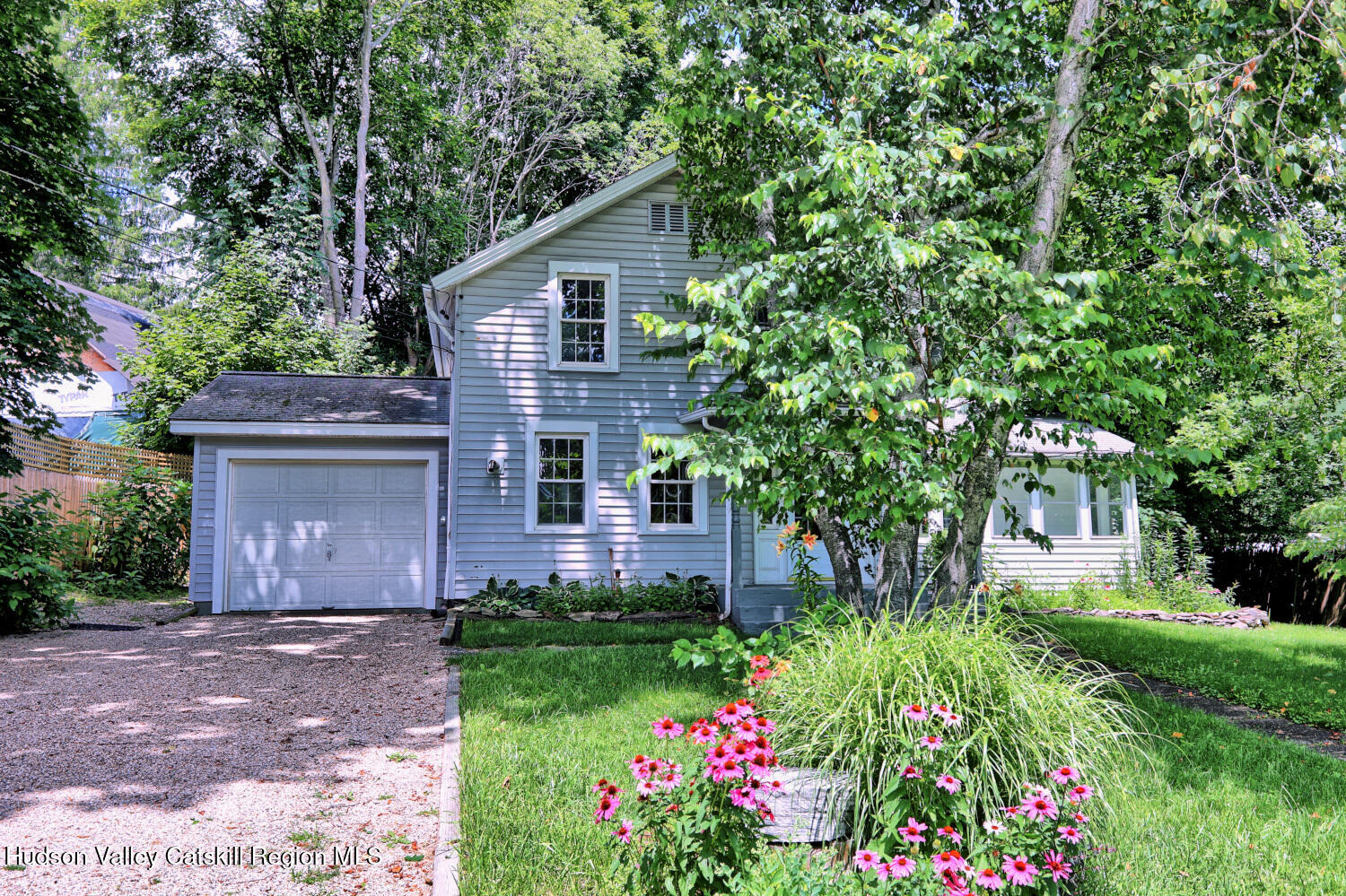 a view of a house with a yard and garden