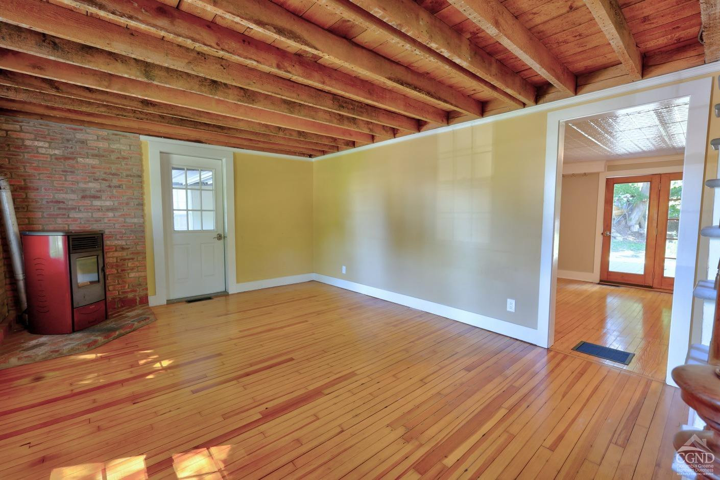 21 Irondale Road Millerton, NY 12546 - Photo 14 of 73 a view of empty room with wooden floor and fireplace